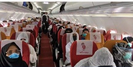 Passengers seated in an aircraft cabin before departure